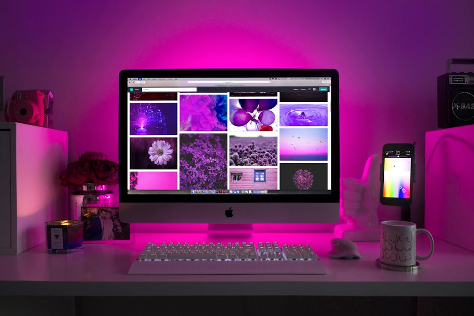 Essential Web Design Mistakes to Avoid in 2025 Modern desk setup with neon lighting and a desktop computer displaying colorful images.